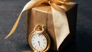 gold-pocket-watch-and-craft-paper-gift-with-ribbon-2021-08-30-16-35-46-utc